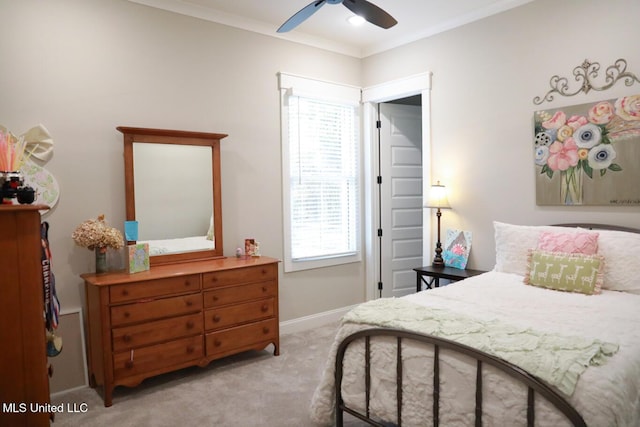 bedroom featuring a ceiling fan, light colored carpet, baseboards, and ornamental molding