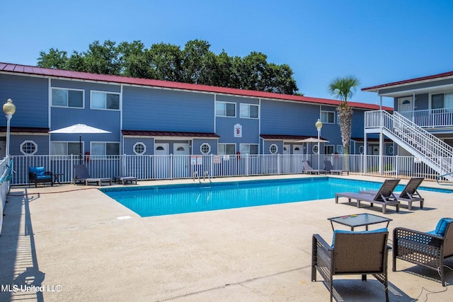 view of swimming pool featuring a patio