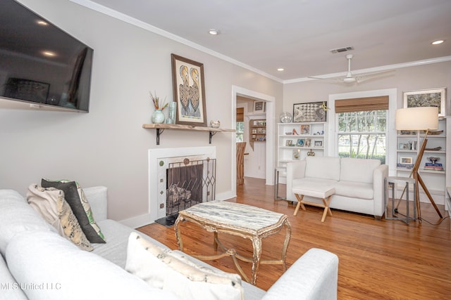 319 Washington Ave, Ocean Springs, MS 39564 - living room with crown molding, wood finished floors, recessed lighting, a fireplace, and ceiling fan