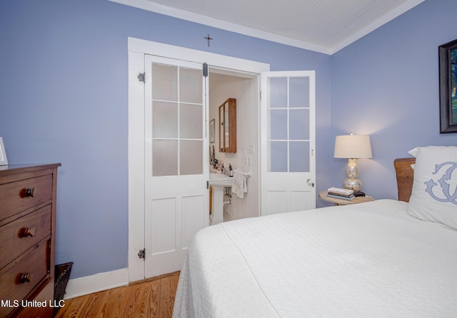 319 Washington Ave, Ocean Springs, MS 39564 - bedroom with light wood-style flooring, crown molding, and baseboards