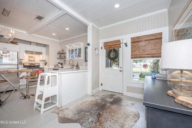 319 Washington Ave, Ocean Springs, MS 39564 - entrance foyer with recessed lighting, beamed ceiling, ornamental molding, baseboards, and light wood-style floors