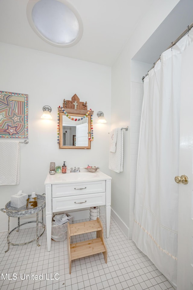 319 Washington Ave, Ocean Springs, MS 39564 - full bathroom with baseboards, vanity, tile patterned floors, and a shower with curtain