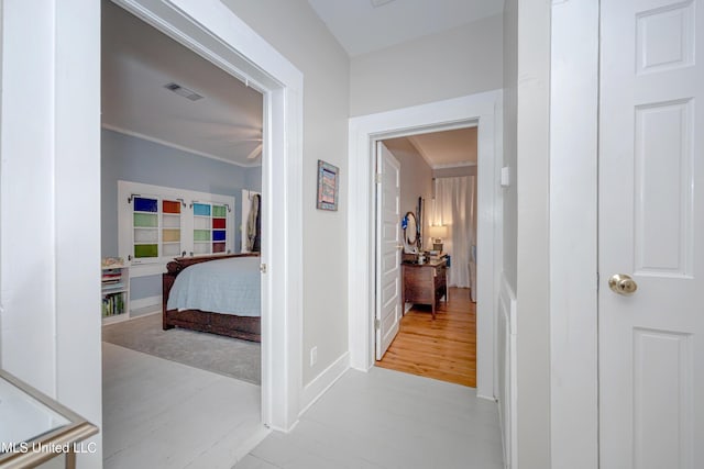 319 Washington Ave, Ocean Springs, MS 39564 - corridor with wood finished floors and crown molding