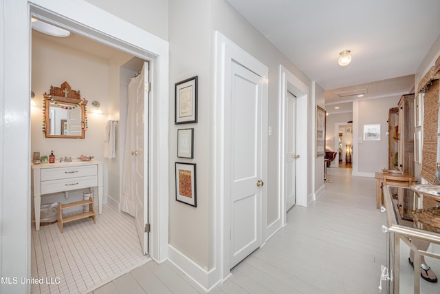 319 Washington Ave, Ocean Springs, MS 39564 - hall with baseboards and light tile patterned floors