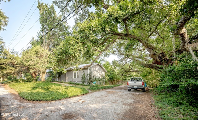 319 Washington Ave, Ocean Springs, MS 39564 - view of property exterior featuring driveway and a lawn