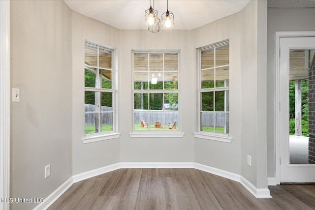 119 Vance Cv, Byhalia, MS 38611 - unfurnished dining area with wood finished floors, baseboards, and a chandelier