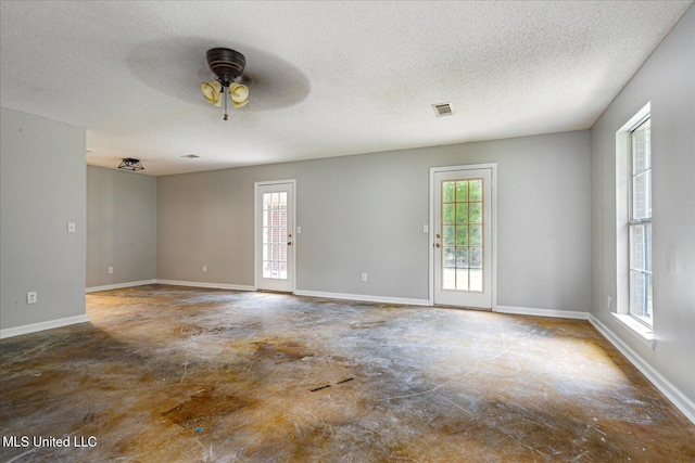 119 Vance Cv, Byhalia, MS 38611 - spare room with unfinished concrete flooring, ceiling fan, a textured ceiling, and baseboards