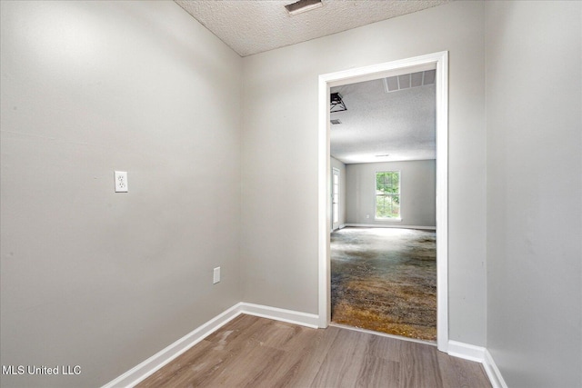 119 Vance Cv, Byhalia, MS 38611 - hallway featuring a textured ceiling, wood finished floors, and baseboards