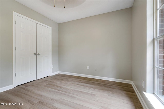 119 Vance Cv, Byhalia, MS 38611 - unfurnished bedroom with wood finished floors, a closet, and baseboards