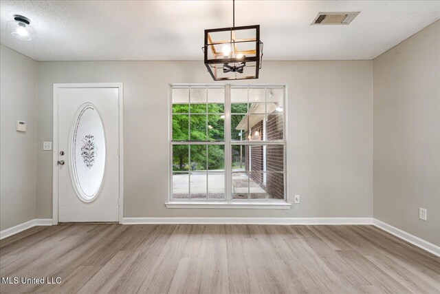 119 Vance Cv, Byhalia, MS 38611 - entrance foyer featuring wood finished floors, a chandelier, and baseboards