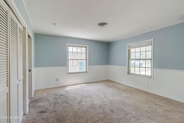 unfurnished bedroom featuring light colored carpet