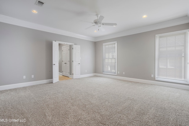 unfurnished room with crown molding, light carpet, and ceiling fan