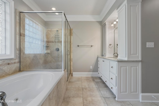 bathroom featuring a wealth of natural light, vanity, separate shower and tub, and ornamental molding