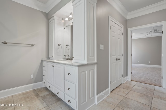 bathroom featuring vanity, crown molding, and tile patterned flooring