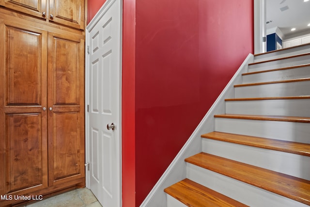 stairway featuring tile patterned flooring