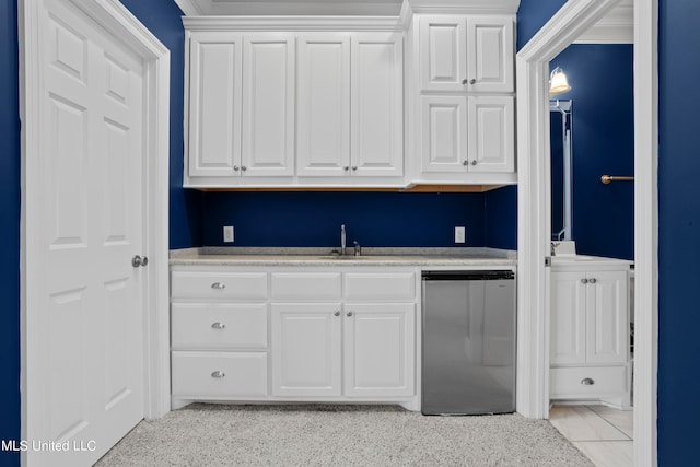 kitchen featuring white cabinets, dishwasher, and sink