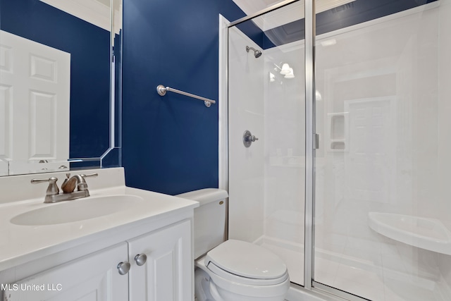 bathroom featuring vanity, toilet, tile patterned floors, and a shower with shower door