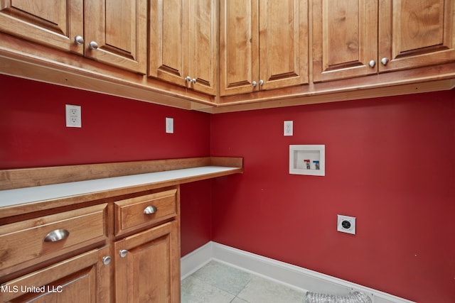 laundry area featuring electric dryer hookup, washer hookup, light tile patterned floors, and cabinets