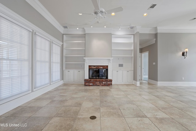 unfurnished living room featuring a brick fireplace, ornamental molding, ceiling fan, and built in shelves