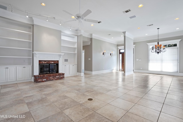 unfurnished living room featuring ornamental molding, light tile patterned flooring, built in features, a fireplace, and ceiling fan with notable chandelier