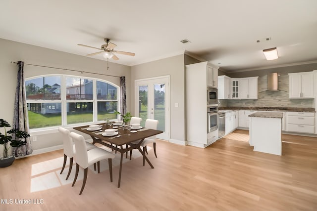 103 Buena Vista Dr, Long Beach, MS 39560 - dining area featuring plenty of natural light, light wood-style flooring, ceiling fan, crown molding, and french doors