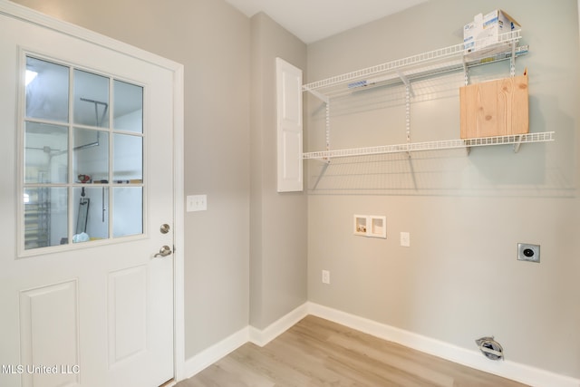 103 Buena Vista Dr, Long Beach, MS 39560 - washroom featuring hookup for an electric dryer, hookup for a washing machine, and light wood-style flooring