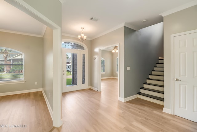 103 Buena Vista Dr, Long Beach, MS 39560 - entryway featuring a chandelier, light wood-style floors, healthy amount of natural light, and crown molding