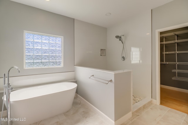 103 Buena Vista Dr, Long Beach, MS 39560 - bathroom with marble finish flooring, a walk in shower, and a freestanding tub