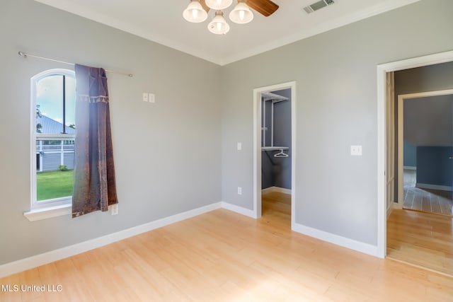 103 Buena Vista Dr, Long Beach, MS 39560 - unfurnished bedroom featuring light wood-style flooring, a walk in closet, and a closet