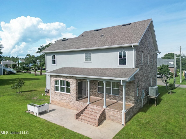 103 Buena Vista Dr, Long Beach, MS 39560 - back of house featuring a shingled roof, a yard, a patio area, and stucco siding