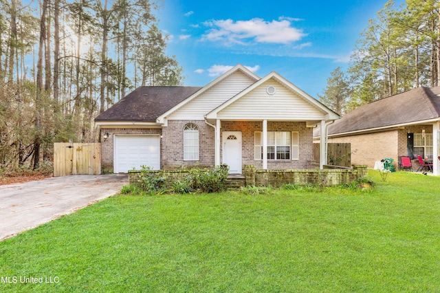 view of front of house featuring covered porch, a front yard, and a garage