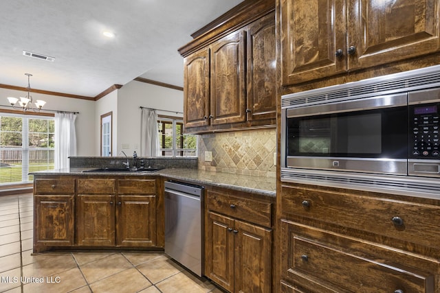 221 Penny Ln, Brandon, MS 39042 - kitchen featuring stainless steel appliances, a sink, ornamental molding, light tile patterned flooring, and a peninsula