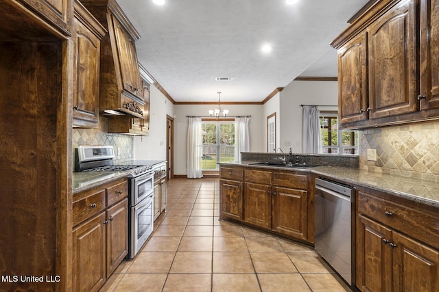 221 Penny Ln, Brandon, MS 39042 - kitchen with appliances with stainless steel finishes, a sink, light tile patterned flooring, a chandelier, and tasteful backsplash