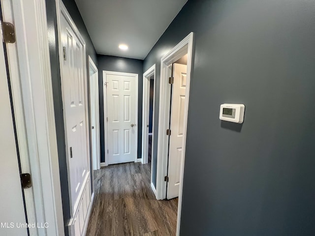 corridor with dark wood-type flooring