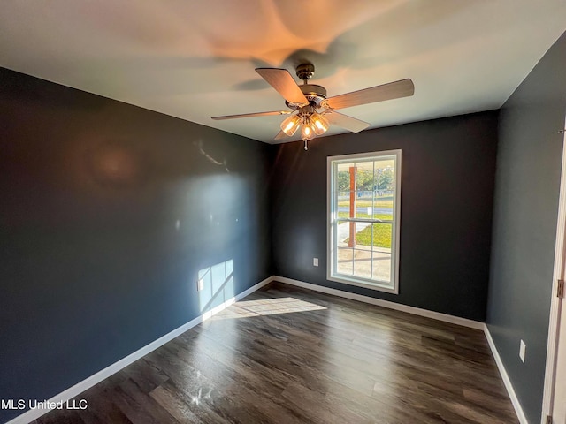 empty room with ceiling fan and dark hardwood / wood-style floors