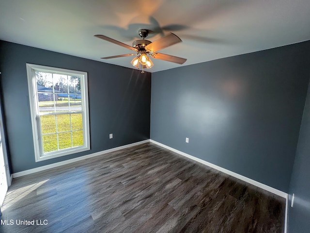 empty room featuring dark hardwood / wood-style flooring and ceiling fan