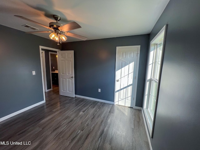 unfurnished room featuring ceiling fan and dark wood-type flooring