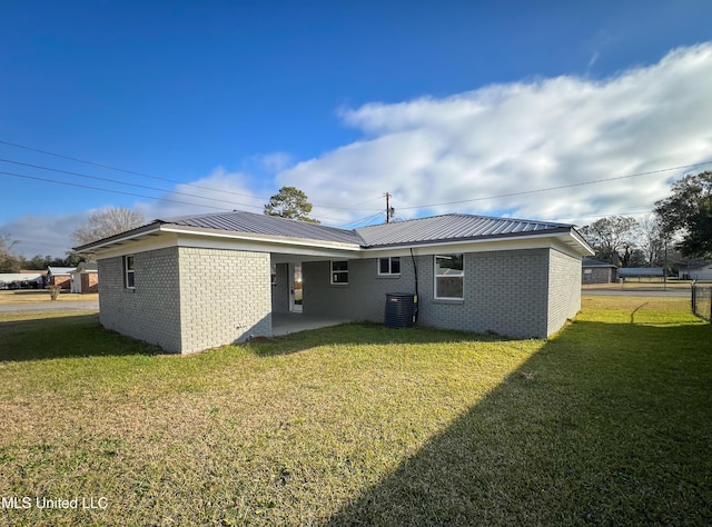 back of house with a lawn, a patio area, and central AC unit