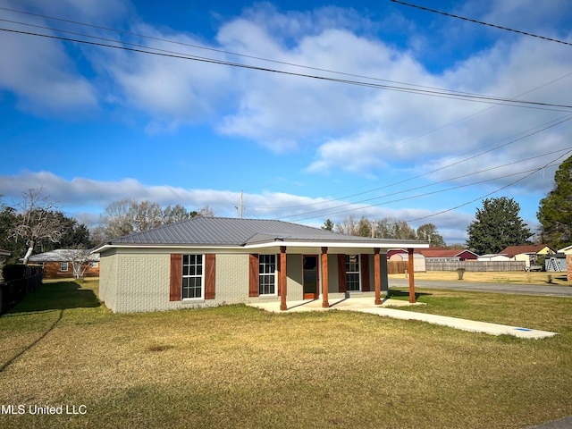 back of property with covered porch and a yard