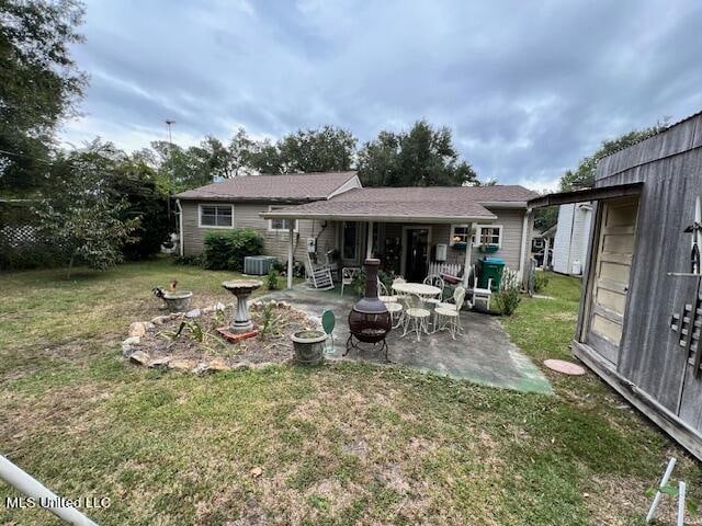 back of house with a patio and a yard