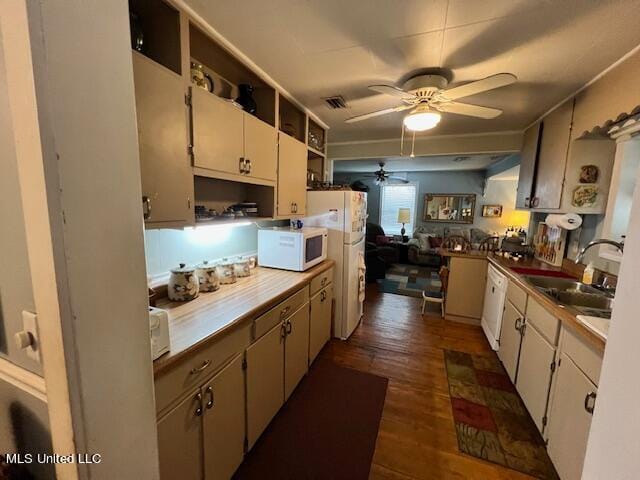 kitchen featuring sink, dark wood-type flooring, white cabinets, and white appliances