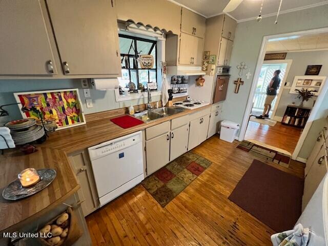 kitchen with white appliances, white cabinetry, light hardwood / wood-style flooring, and plenty of natural light