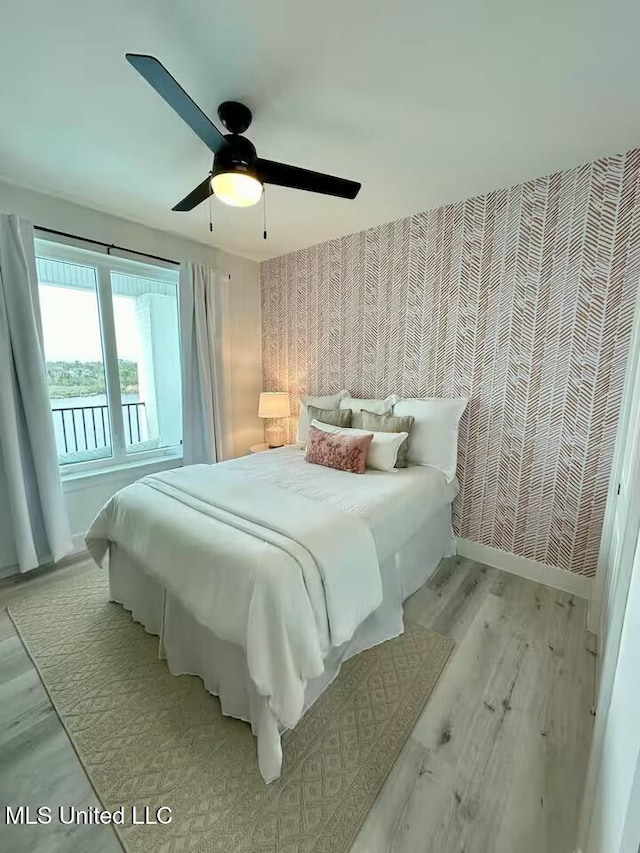 bedroom with light hardwood / wood-style flooring and ceiling fan