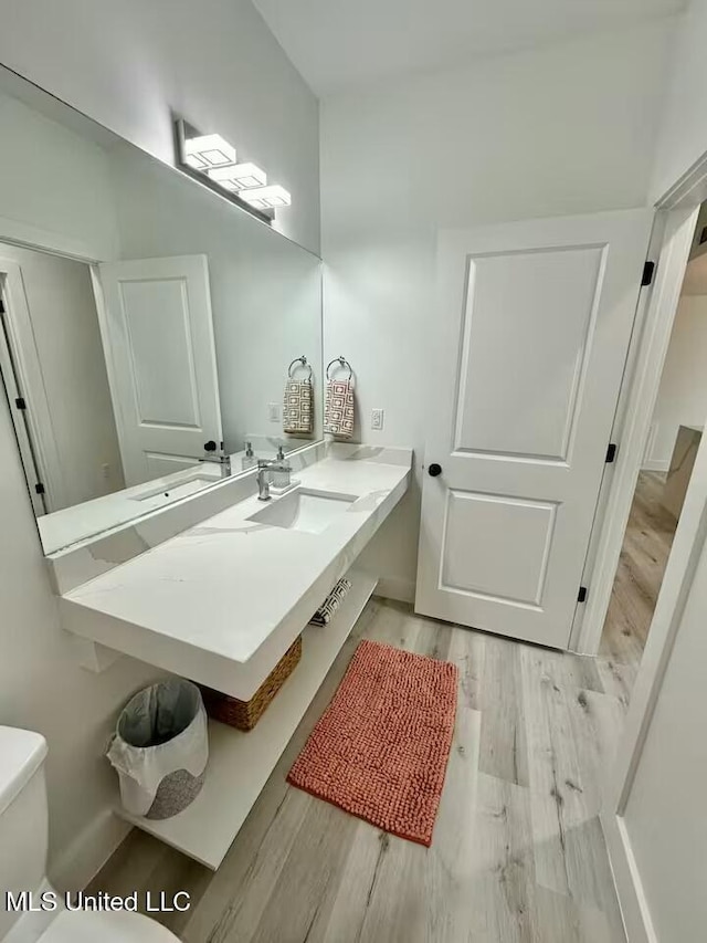 bathroom with vanity, hardwood / wood-style flooring, and toilet