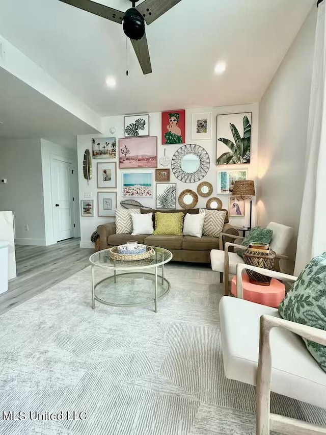 living room with light hardwood / wood-style flooring and ceiling fan