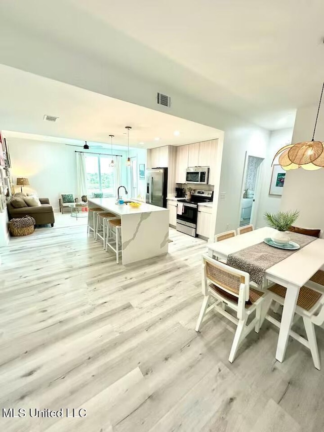 interior space featuring sink and light wood-type flooring