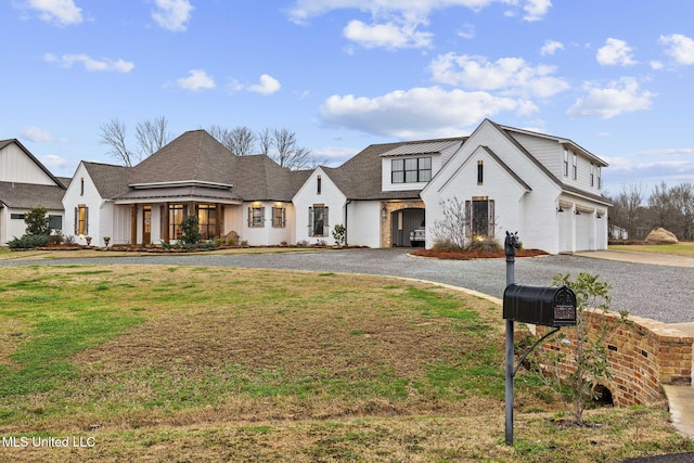 view of front of house featuring a garage and a front lawn