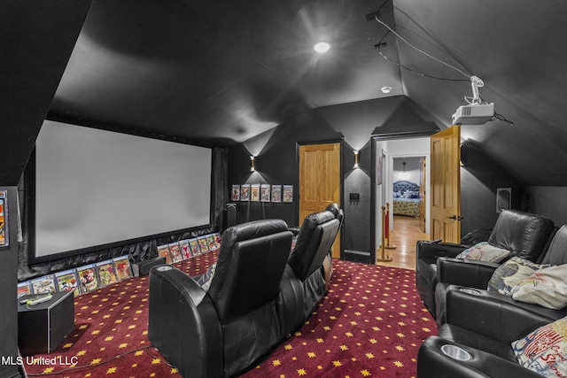 carpeted home theater with vaulted ceiling