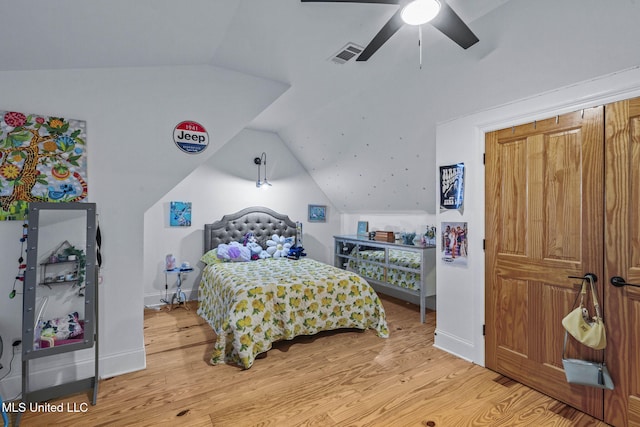 bedroom featuring hardwood / wood-style flooring, vaulted ceiling, and ceiling fan