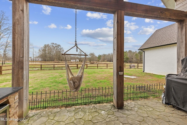 exterior space with a patio and a rural view